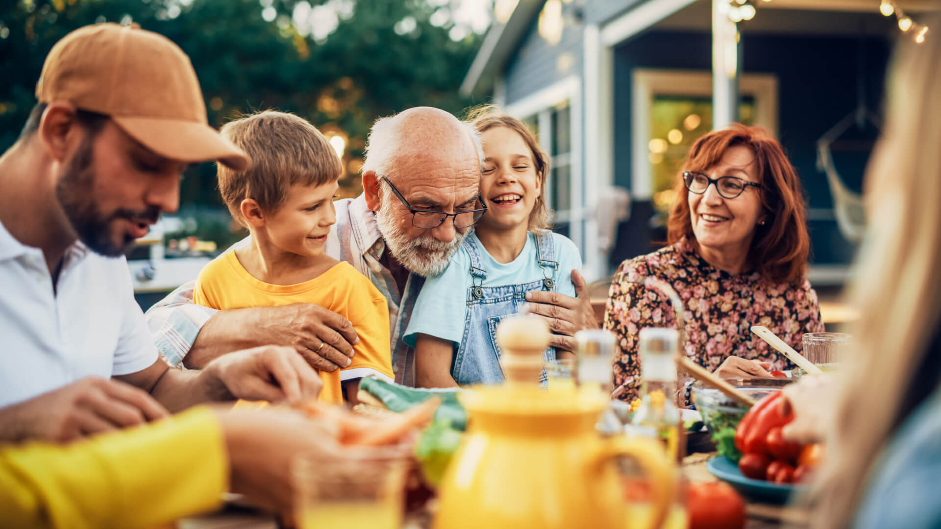 Three generations of a family sharing an outdoor meal